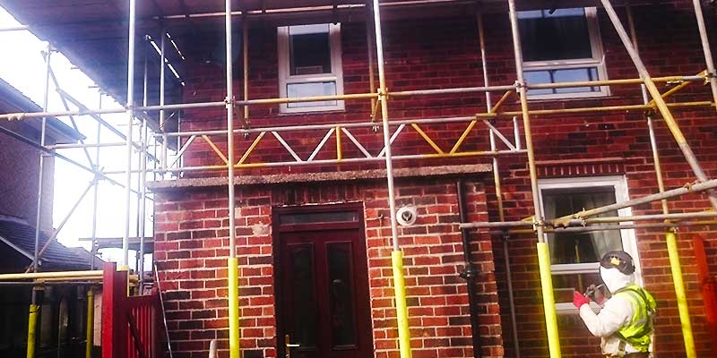 close up view of a small semi detached home fully surrounded with scaffold all installed by brook scaffolding of sheffield