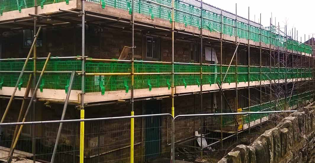 brook scaffoldings specialists erecting scaffold around an unusually shaped stone building