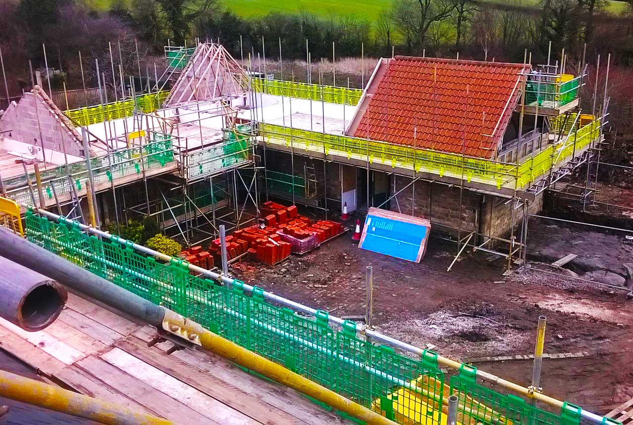 brook scaffoldings team of commercial scaffolders erecting scaffold around a very large unusually shaped circular commercial retail building