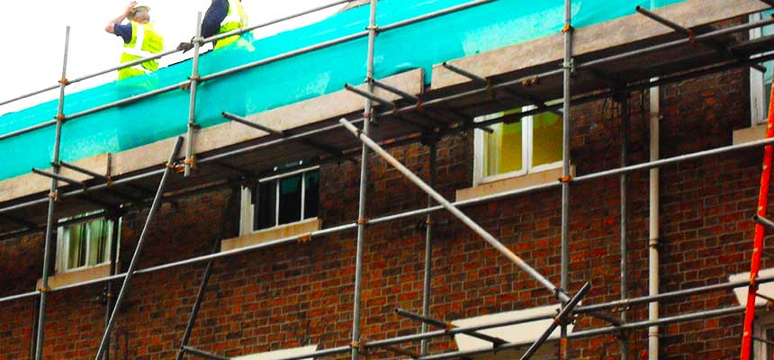 close up of two brook scaffolding commercial retail scaffold surveyors checking scaffolding for safety on a very high commercial scaffold platform