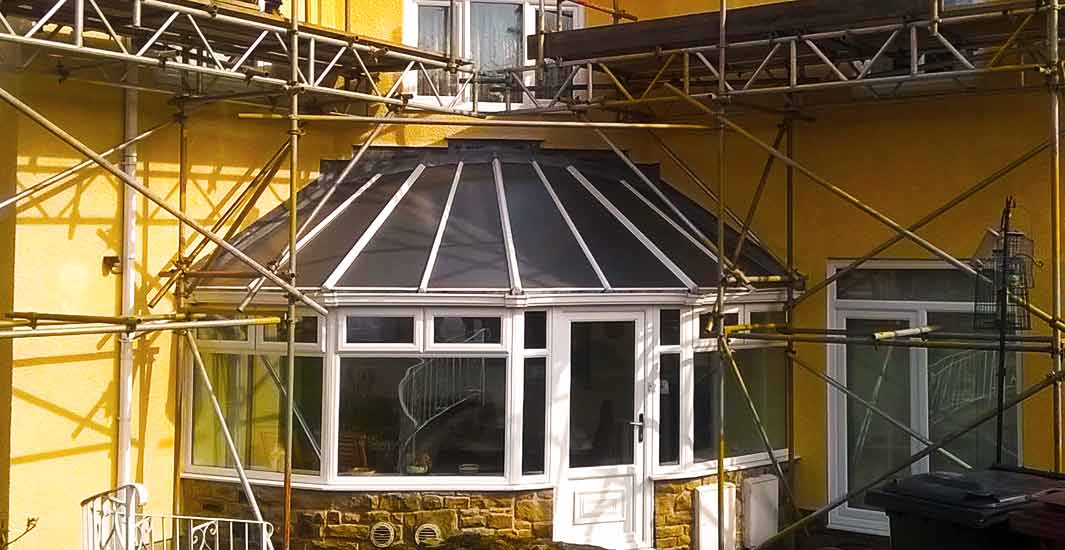 close up front view of a very attractive sheffield beige domestic property undergoing building work via brooks scaffolding erected around the entire property