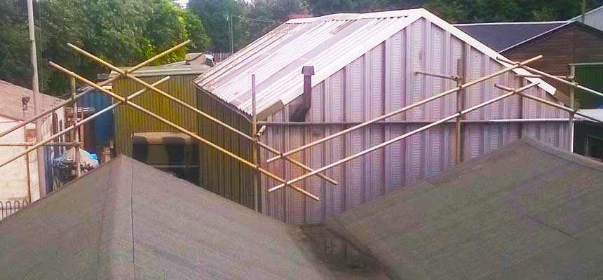 a double v large factory roof with a very efficeint scaffold design erected way above the roof tops