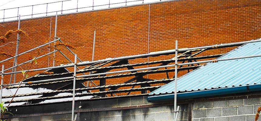 two scaffolders repairing damaged scaffolding around a chesterfield factory