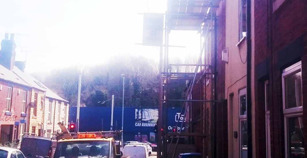 distance view of a brick built shefield home with scaffolding erected by brook scaffolding for trademen to carry out building works