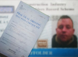 close up view of our newly qualified scaffolder ashly clutching his certificates