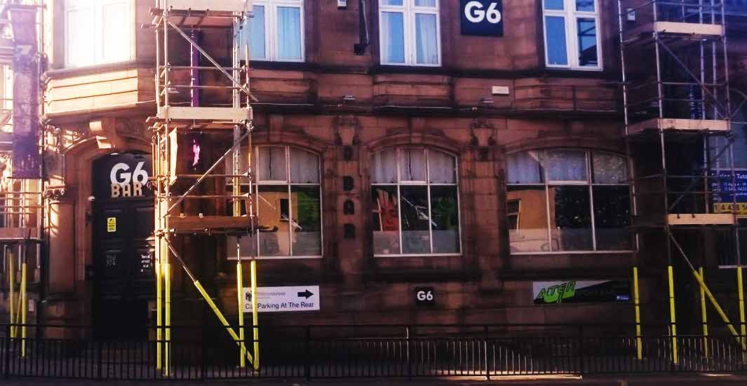 a prominent sheffield retail shop sporting 3 seperate small tower scaffolds with access to and from the shop entrance