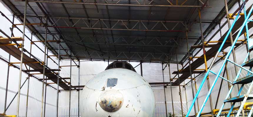 side angled close up of a temporary roof constructed from just scaffold by brooks of sheffield around an airplane project