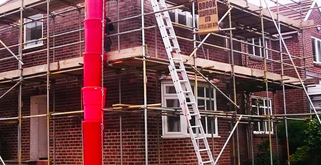 close up view of sheffield scaffolding erectors studying scaffold design plans and erecting scaffold